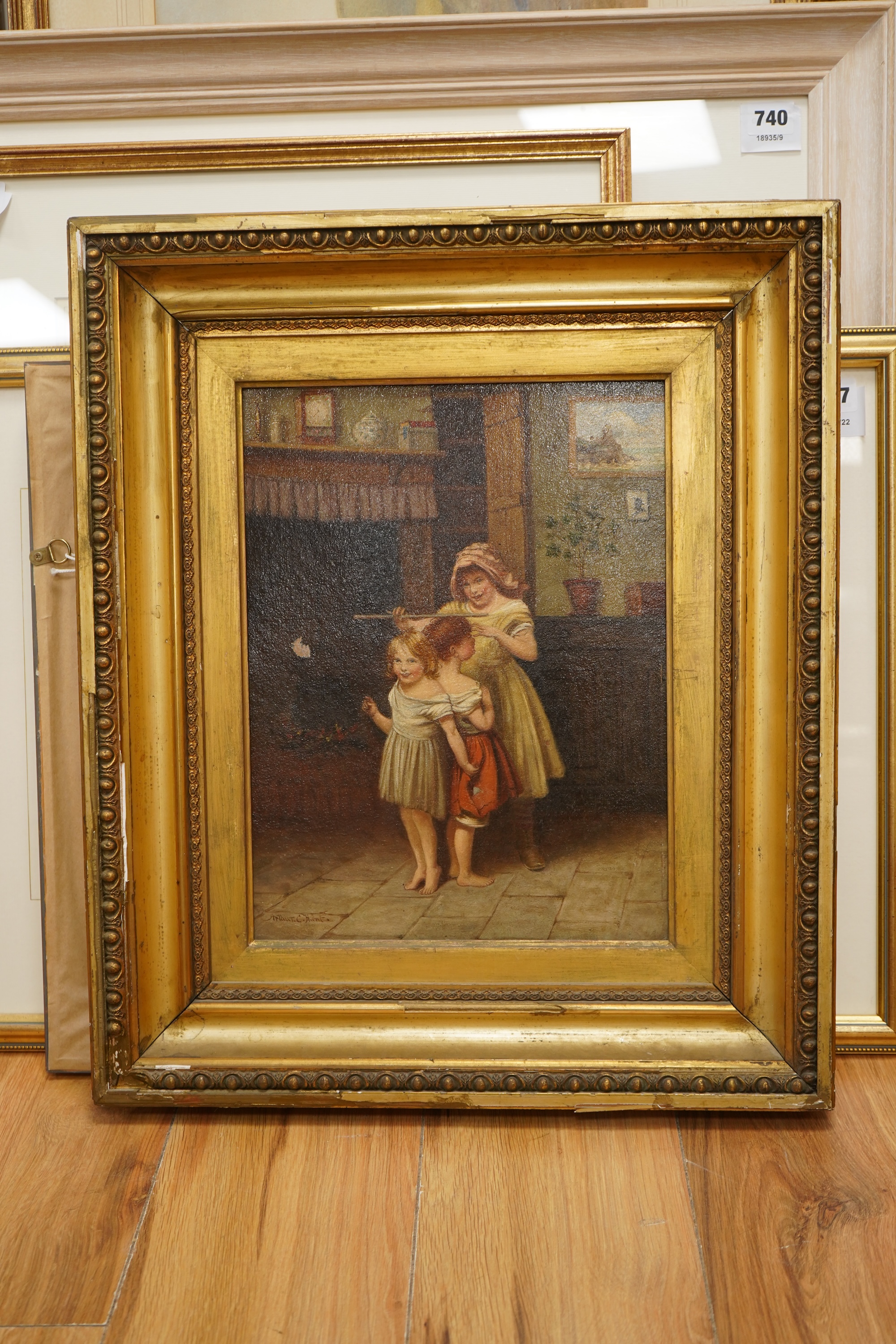 Arthur C Hunt (fl.1863-1902), Children measuring their height, signed, oil on panel, 36 x 27cm, gilt framed